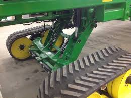 Yellow idlers and green planter undercarriage tracks