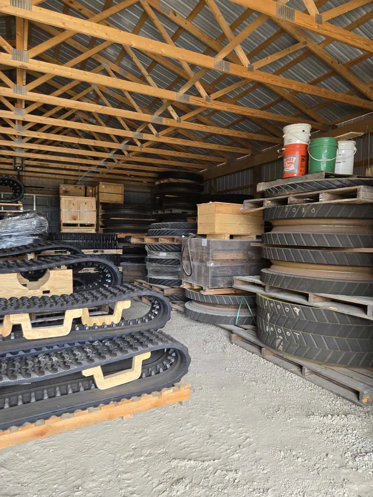 Stacks of ag tracks and wheels on pallets in the Track Farmer warehouse, Long Prairie MN