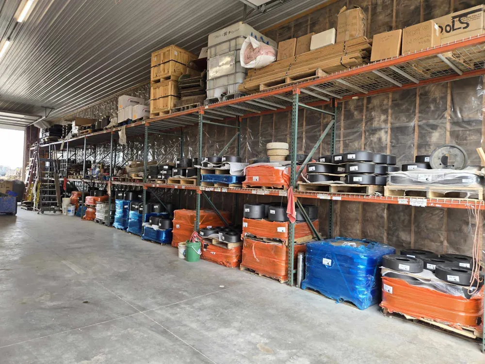 Steel racks of Superior poly wheels and ag tracks inside the Track Farmer warehouse, Long Prairie MN
